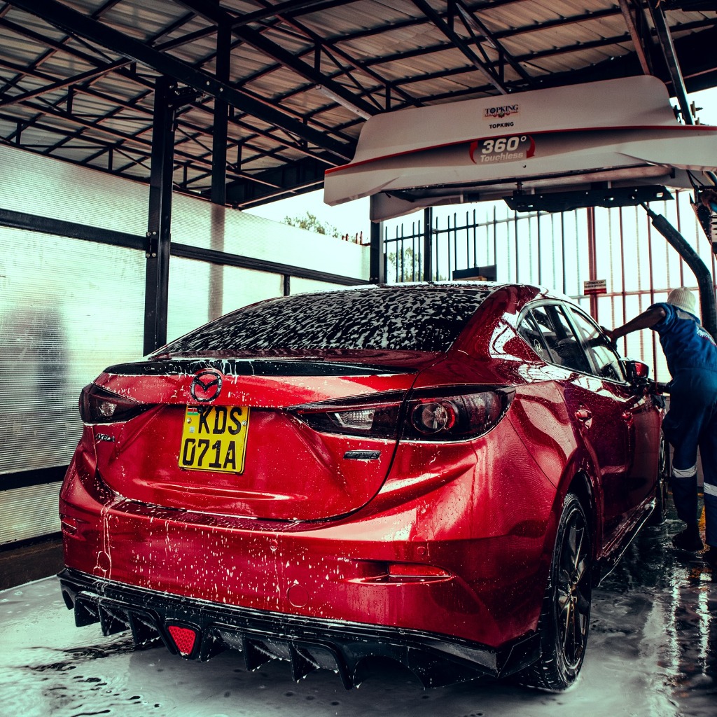 Red Mazda 3 Sedan getting washed